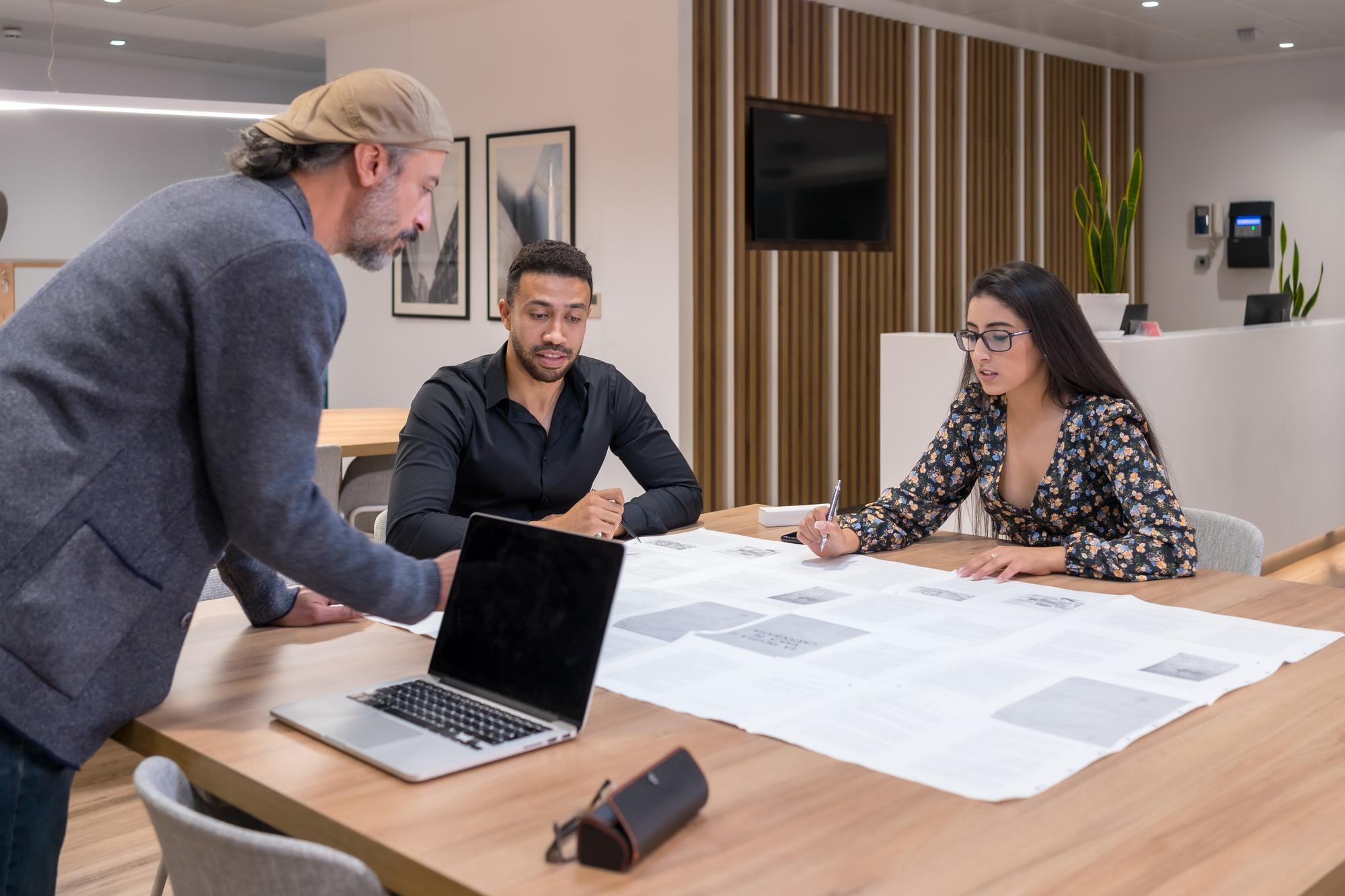 agent discussing apartment floorplan with clients